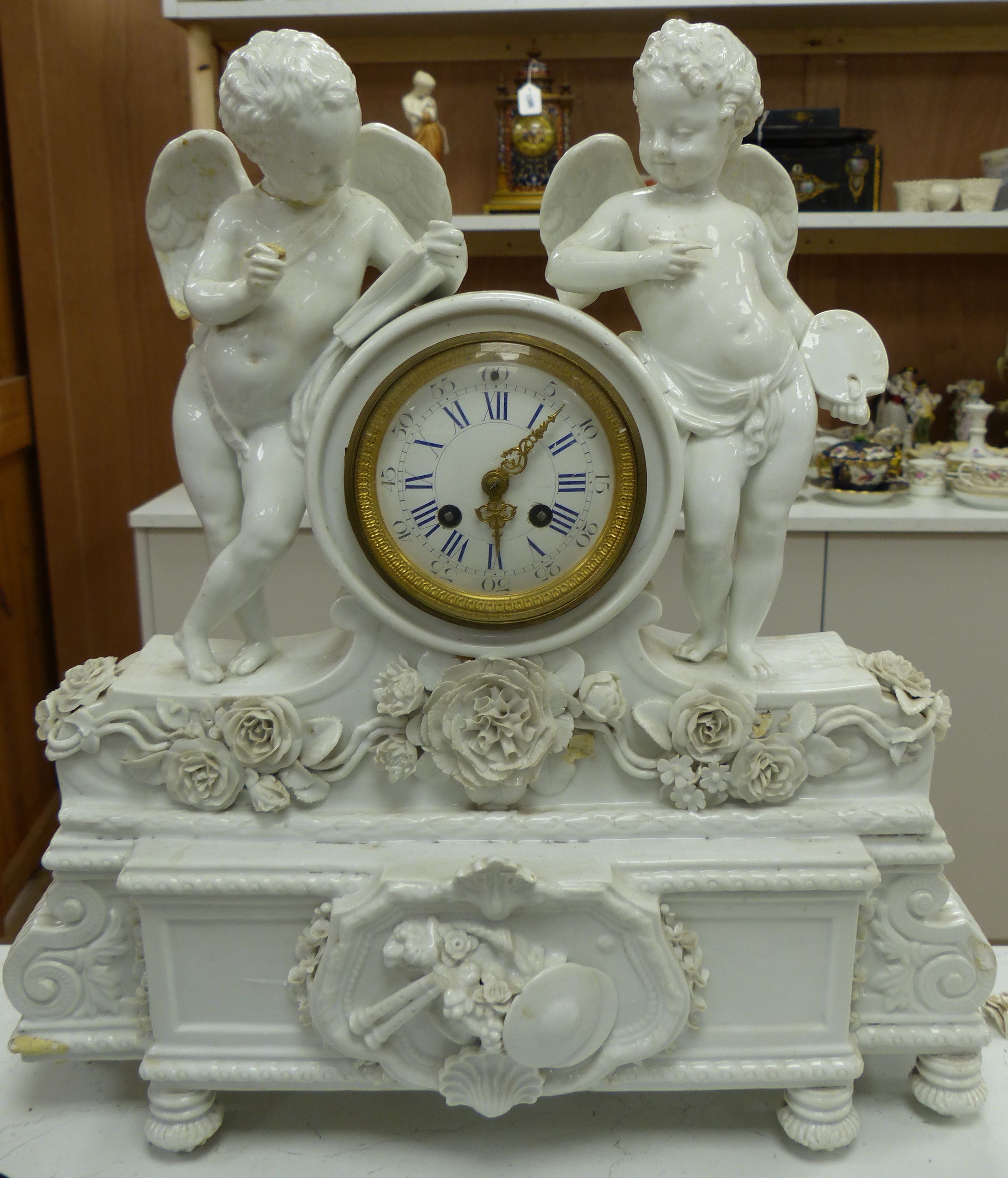 A large French porcelain white glazed cherub mantel clock, height 49cm